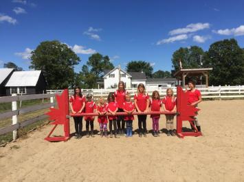 Camp attendees posing with red shirts at Preston Rosedale Summer Camp